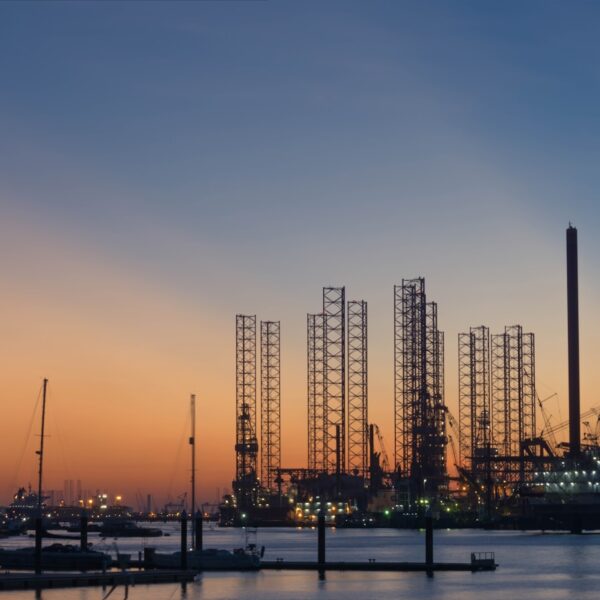 silhouette of building construction beside the river